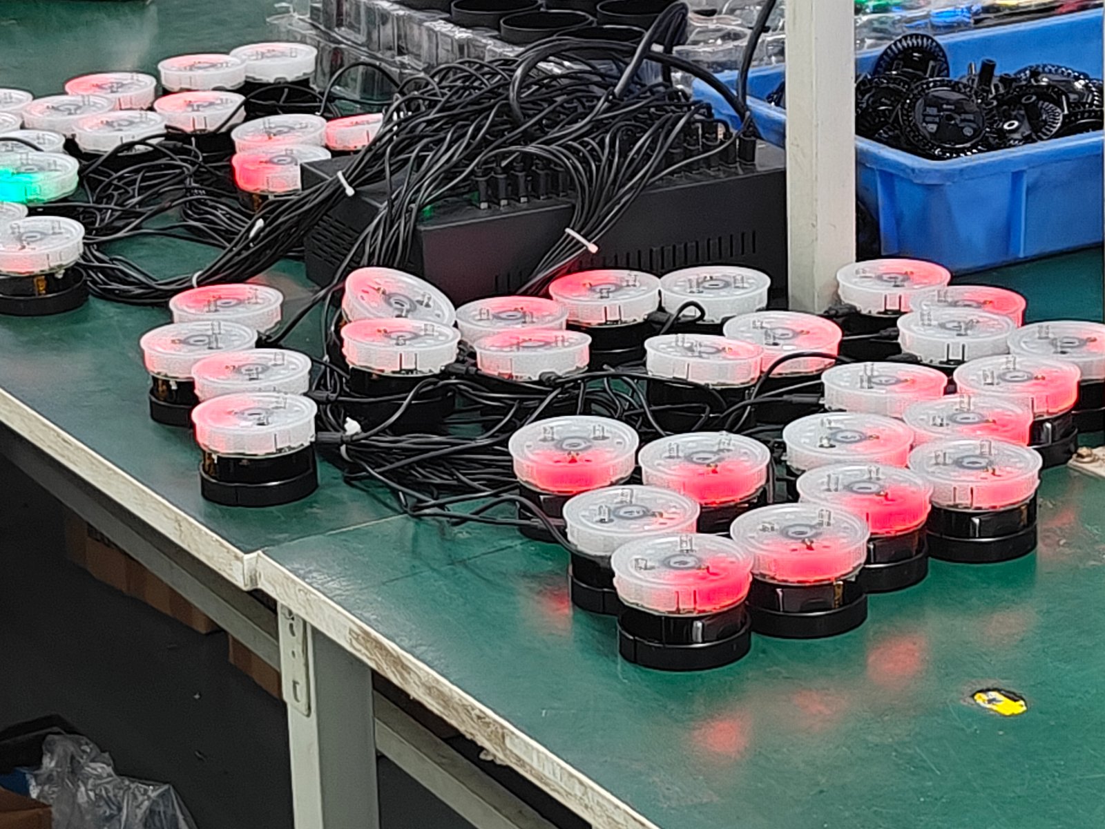 Rows of diffuser light modules glowing red and green on a test bench