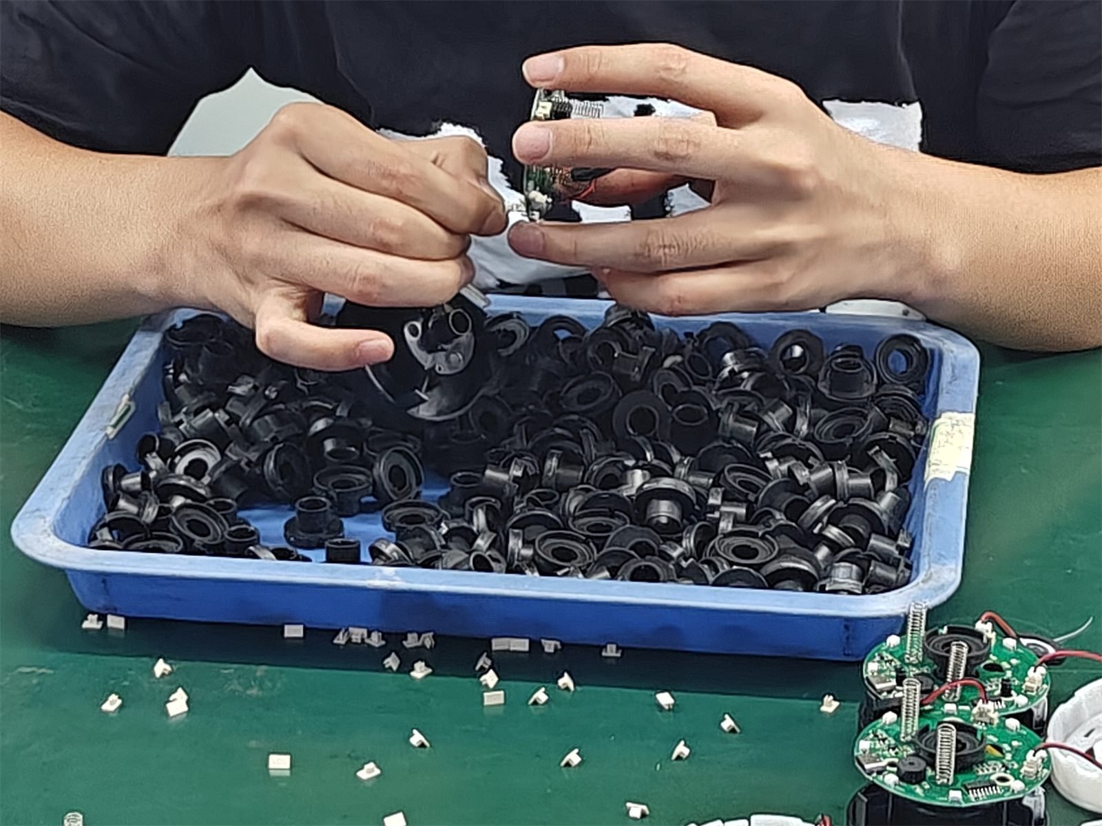 Workers assembling car accessory housings on the Yuehang production line